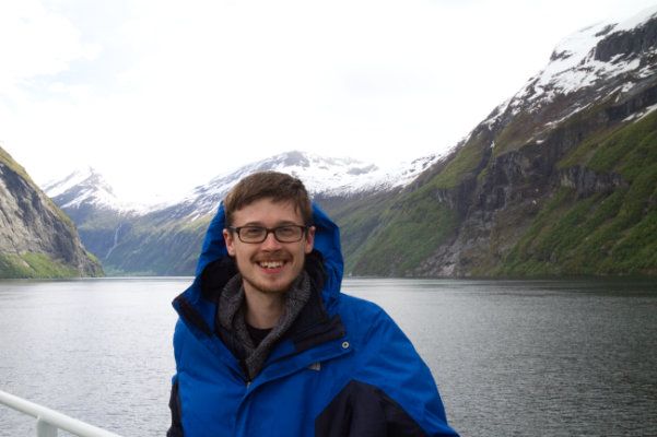 Me standing next to mountains in a fjord in Norway